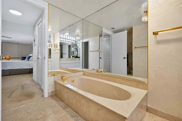 a bathroom with a tub a double vanity sink and mirror