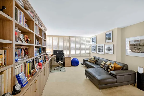 a living room with furniture a book shelf and a book shelf