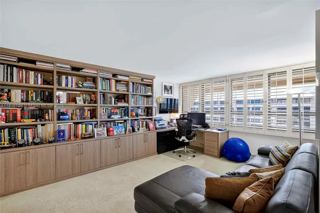 a living room with furniture a bookshelf and a book shelf