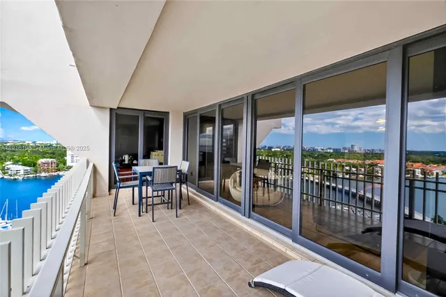 a dining room with furniture and a floor to ceiling window