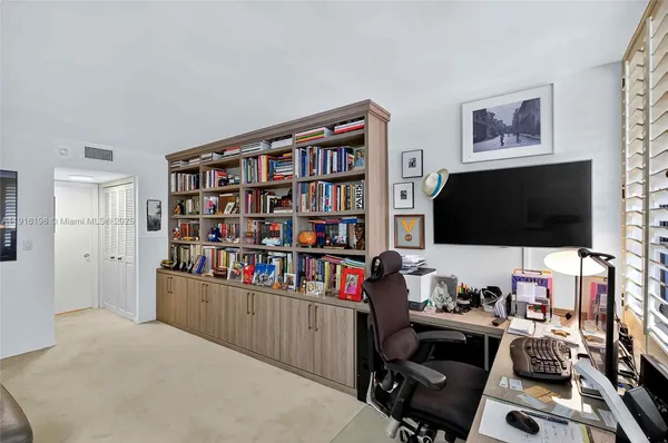 a living room with lots of furniture and a book shelf