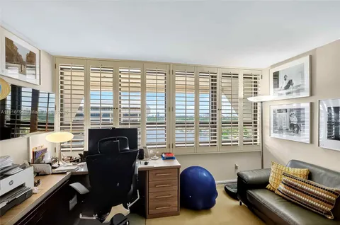 a living room with furniture and a book shelf