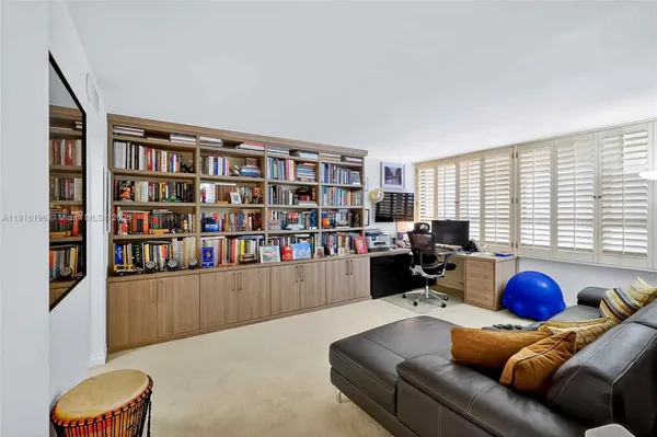 a bathroom with a sink a toilet a mirror and shower