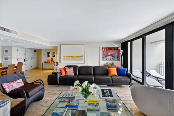 a living room with furniture fireplace and a large window