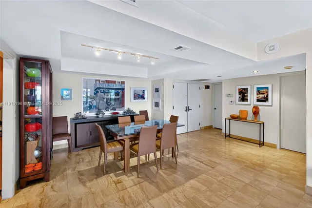 a view of a dining room with furniture and a rug