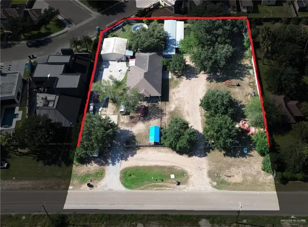 an aerial view of a house with garden space and street view