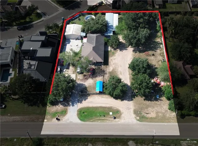 an aerial view of a house with garden space and street view