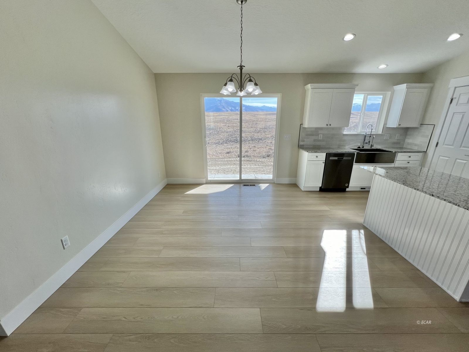 1096 Sun Vly Road Spring Creek, NV 89815 - Photo 10 of 31 a view of a kitchen with furniture and wooden floor