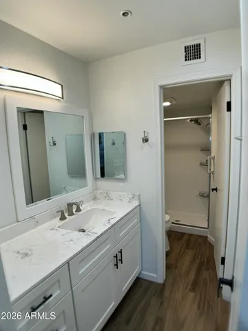 a spacious bathroom with a shower sink and mirror