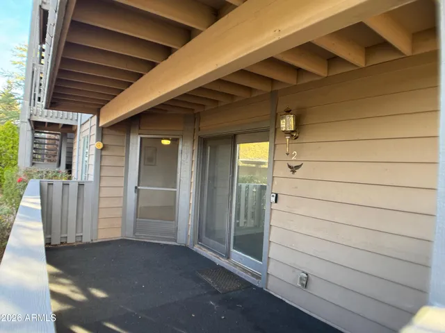 a view of a porch with wooden floor and roof