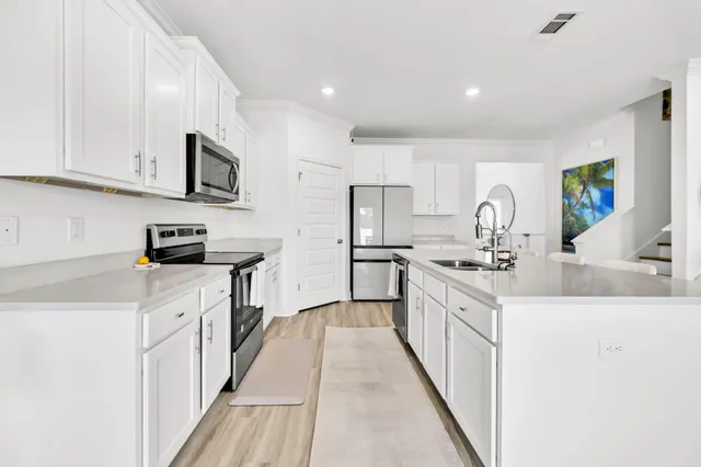 a kitchen with cabinets and white appliances