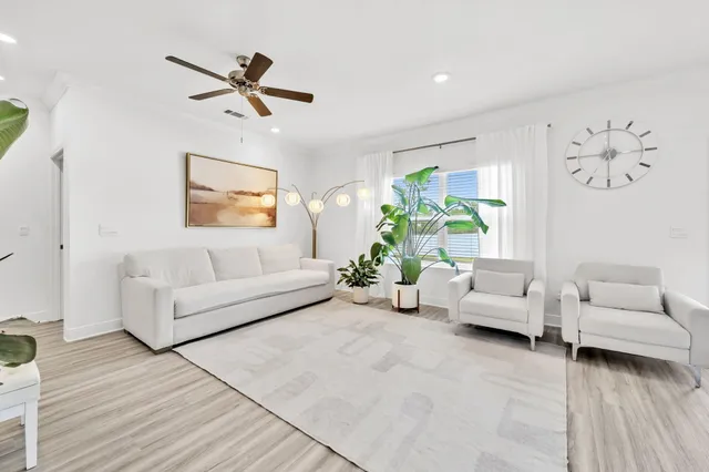 a living room with kitchen island furniture and a chandelier