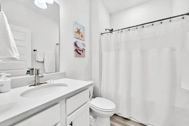 a spacious bedroom with a bed and a chandelier