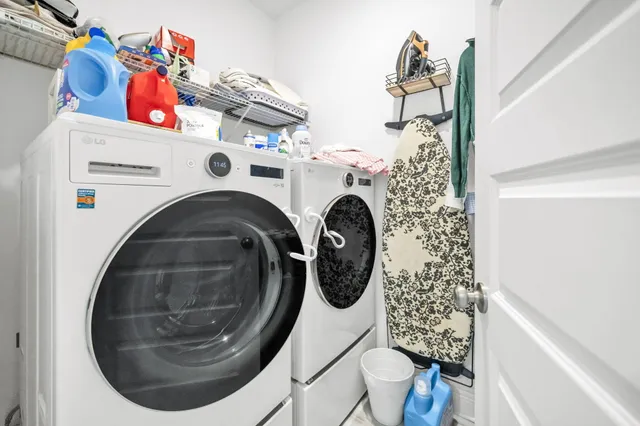 a room with a bed a flat screen tv and dresser