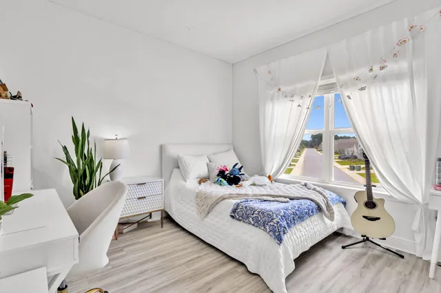 a view of a big yard with an ocean view