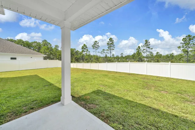 a view of a house with a yard and garage