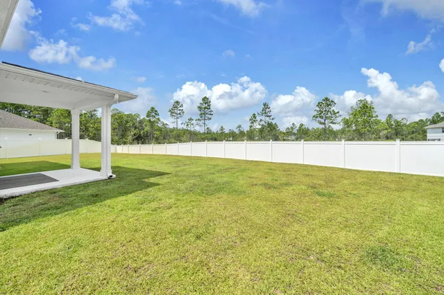 a view of a swimming pool with outdoor seating and plants