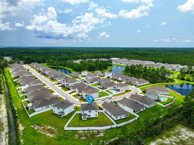 a view of a big yard with table and chairs