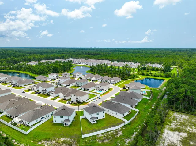 an aerial view of a house with a garden and swimming pool