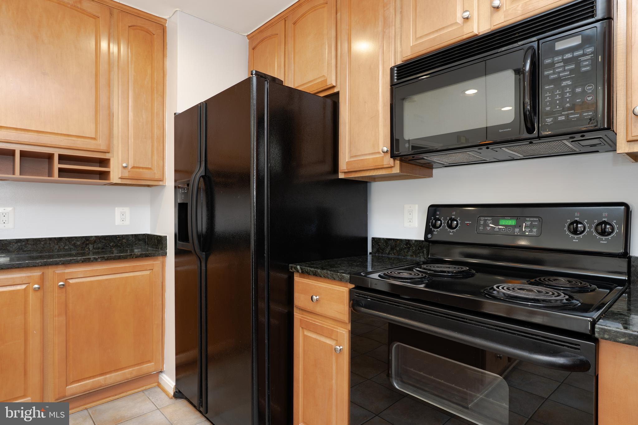 2011 Pieris Court Vienna, VA 22182 - Photo 11 of 39 a kitchen with stainless steel appliances granite countertop a refrigerator and a stove top oven