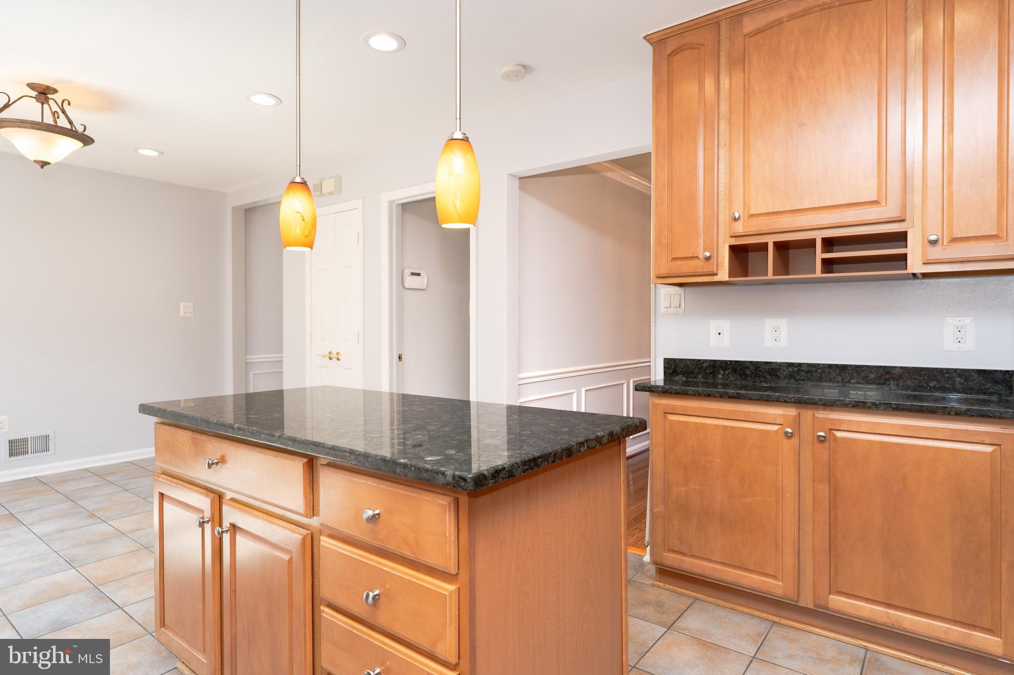 2011 Pieris Court Vienna, VA 22182 - Photo 12 of 39 a kitchen with stainless steel appliances granite countertop a sink a stove and a refrigerator