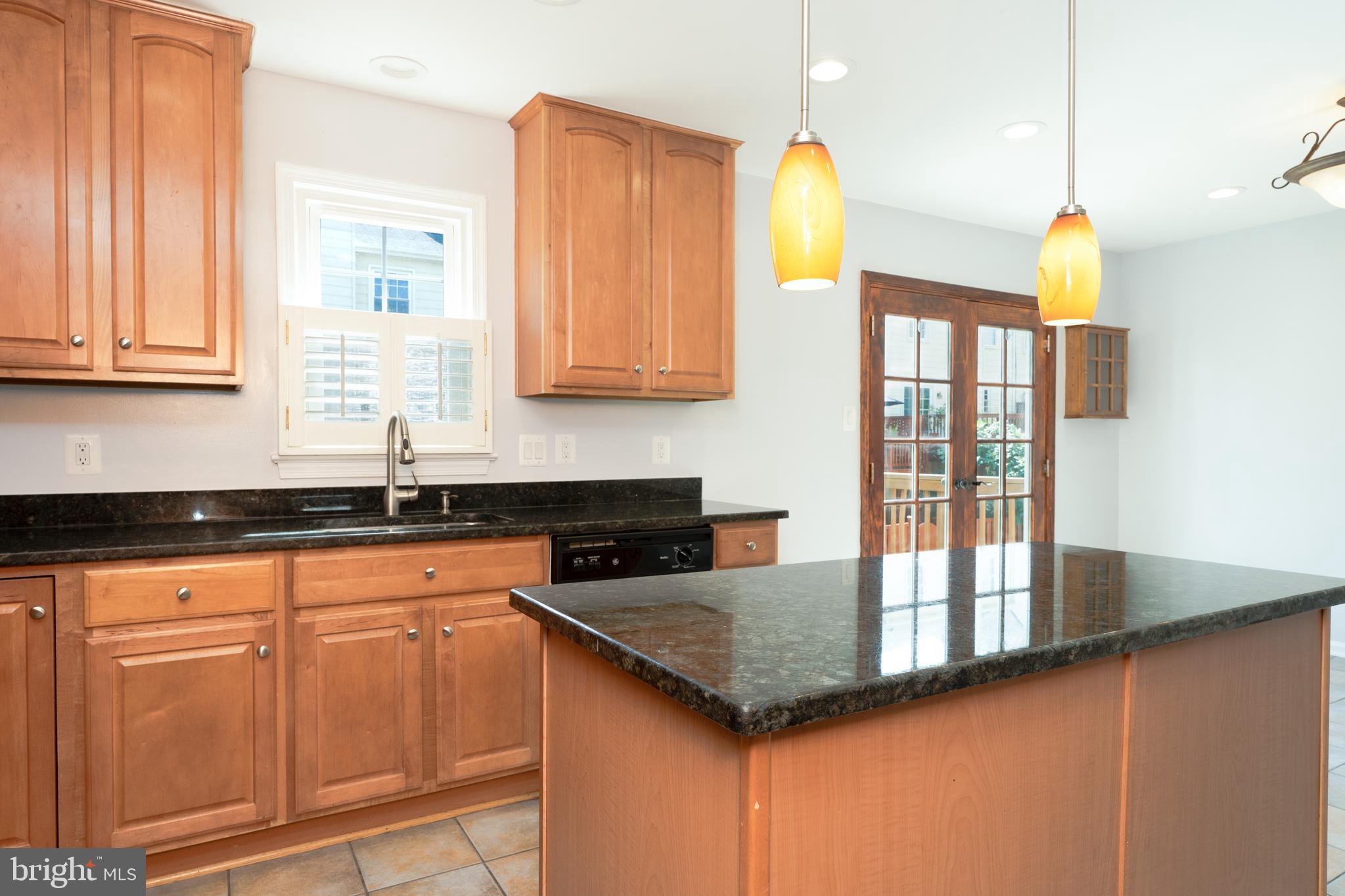 2011 Pieris Court Vienna, VA 22182 - Photo 13 of 39 a kitchen with granite countertop a sink a stove and cabinets