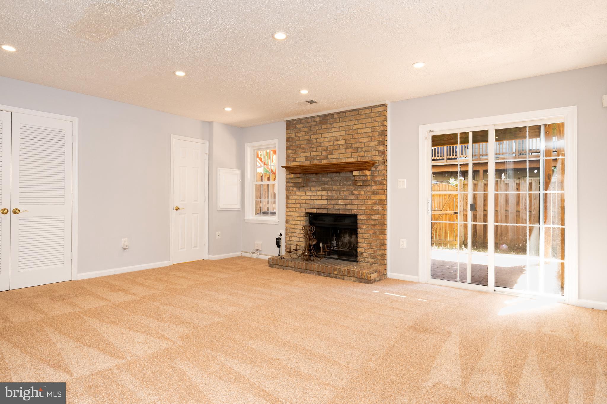 2011 Pieris Court Vienna, VA 22182 - Photo 17 of 39 a view of an empty room with a fireplace and a window