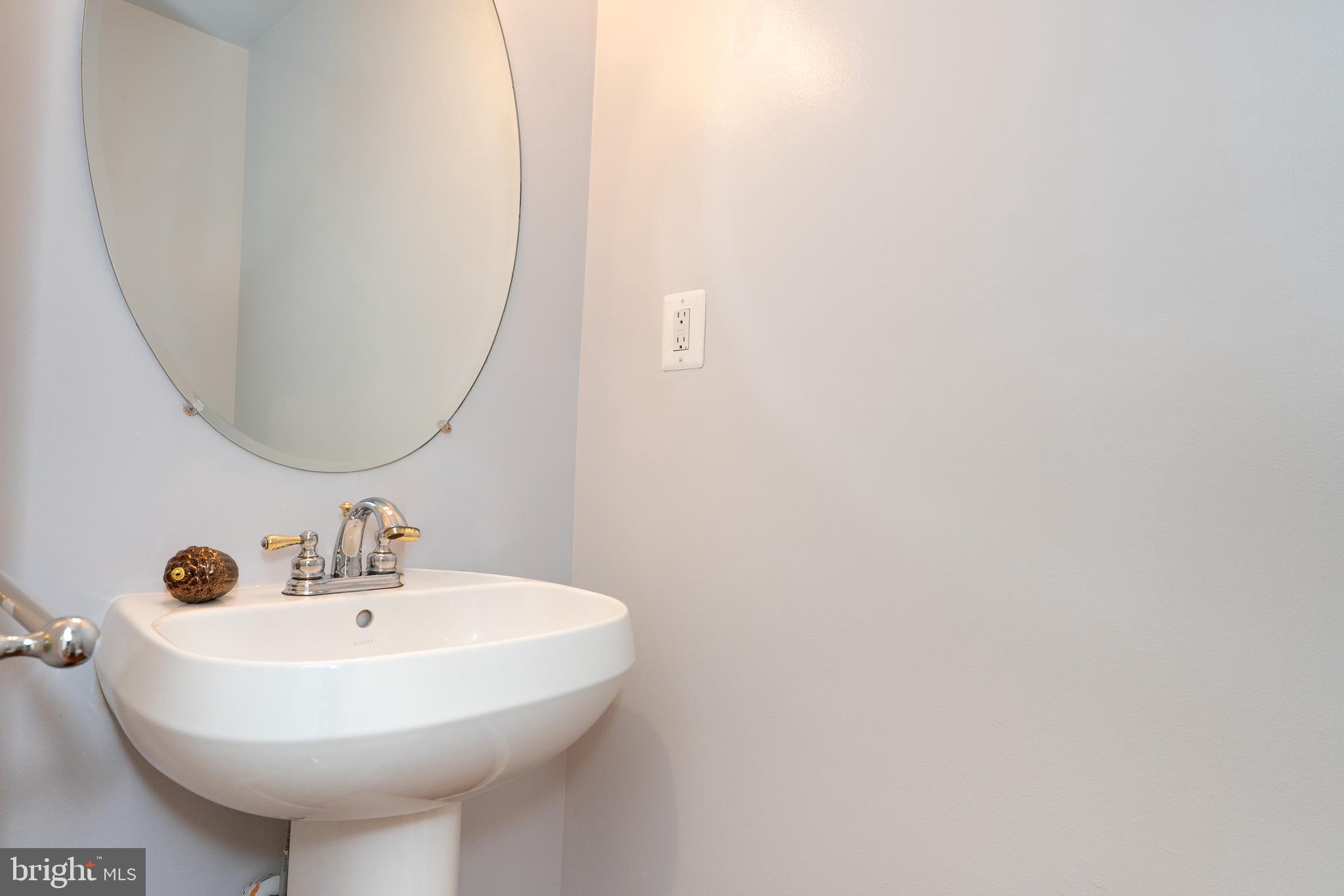 2011 Pieris Court Vienna, VA 22182 - Photo 24 of 39 a bathroom with a sink and a mirror