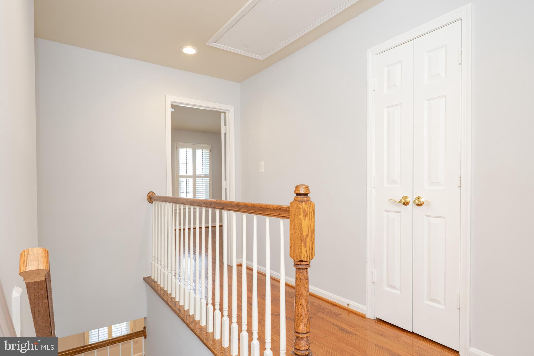 2011 Pieris Court Vienna, VA 22182 - Photo 25 of 39 a view of a hallway with wooden floor and a bathroom