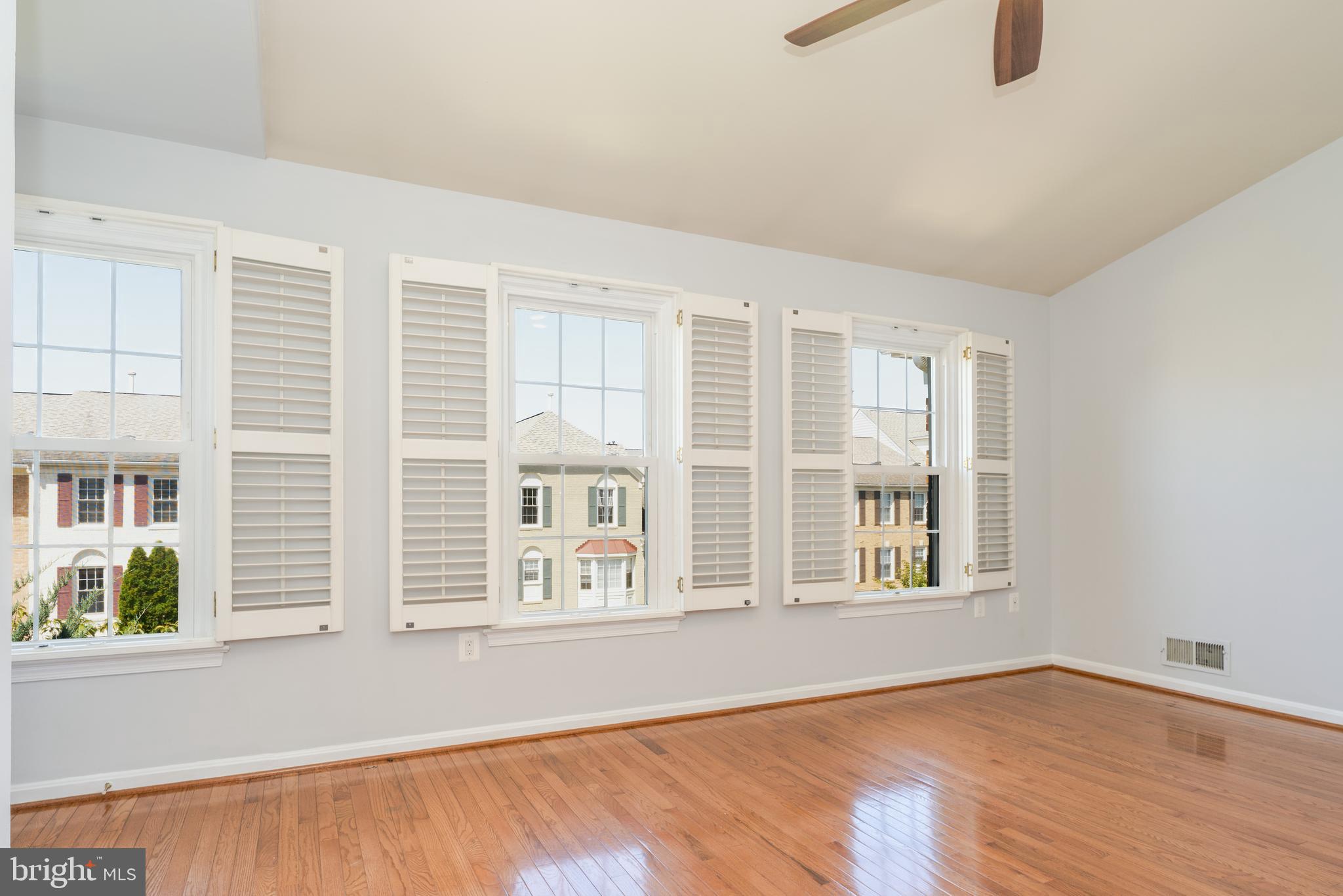2011 Pieris Court Vienna, VA 22182 - Photo 31 of 39 an empty room with wooden floor and windows