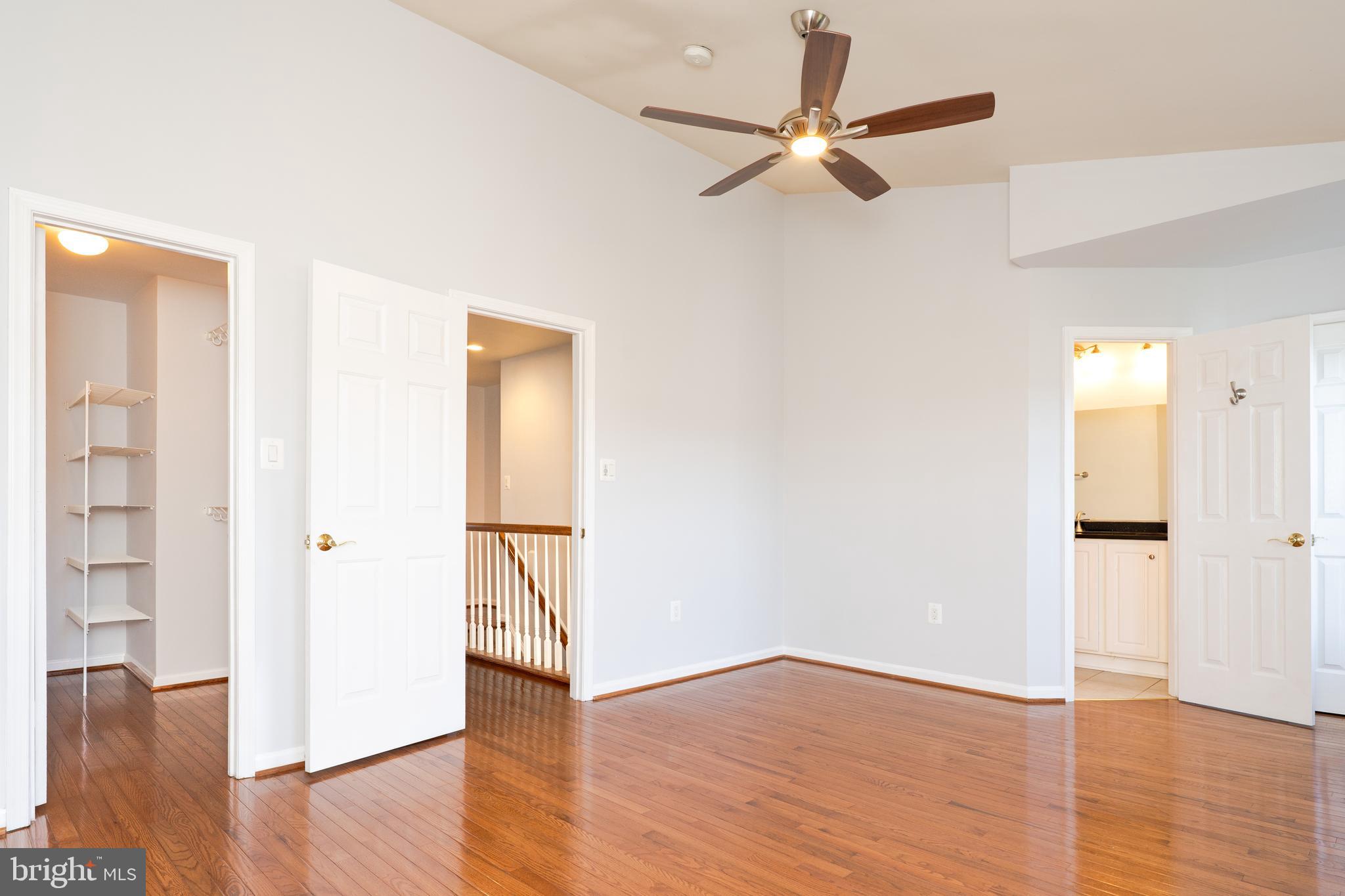 2011 Pieris Court Vienna, VA 22182 - Photo 33 of 39 an empty room with wooden floor a ceiling fan and a window