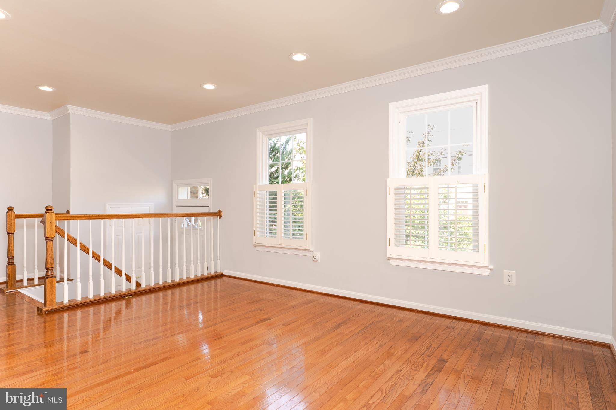 2011 Pieris Court Vienna, VA 22182 - Photo 4 of 39 an empty room with wooden floor and windows