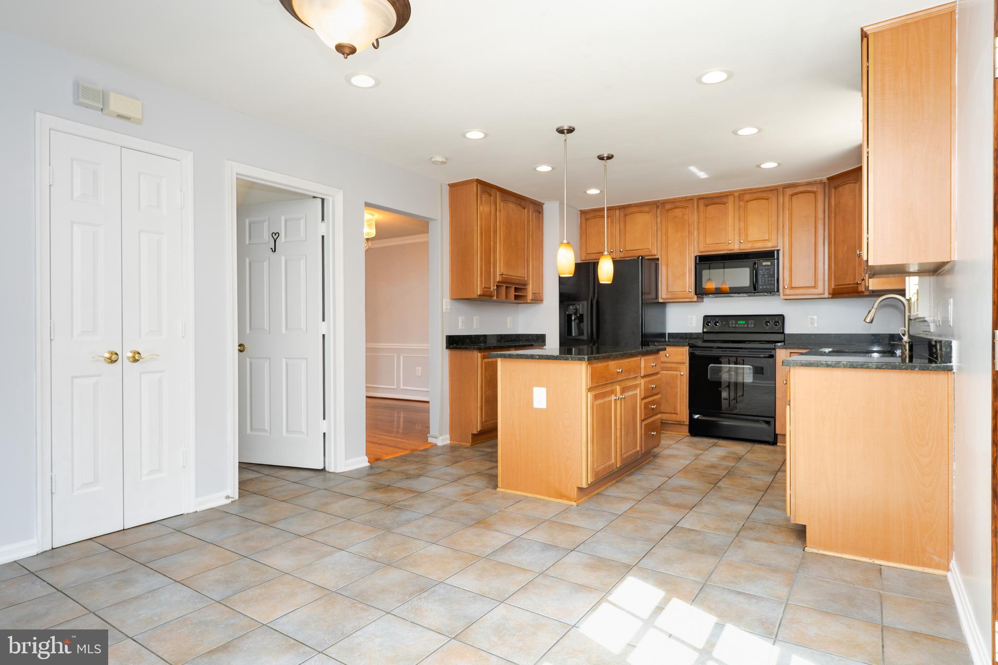 2011 Pieris Court Vienna, VA 22182 - Photo 8 of 39 a kitchen with stainless steel appliances granite countertop a refrigerator a stove top oven and a sink