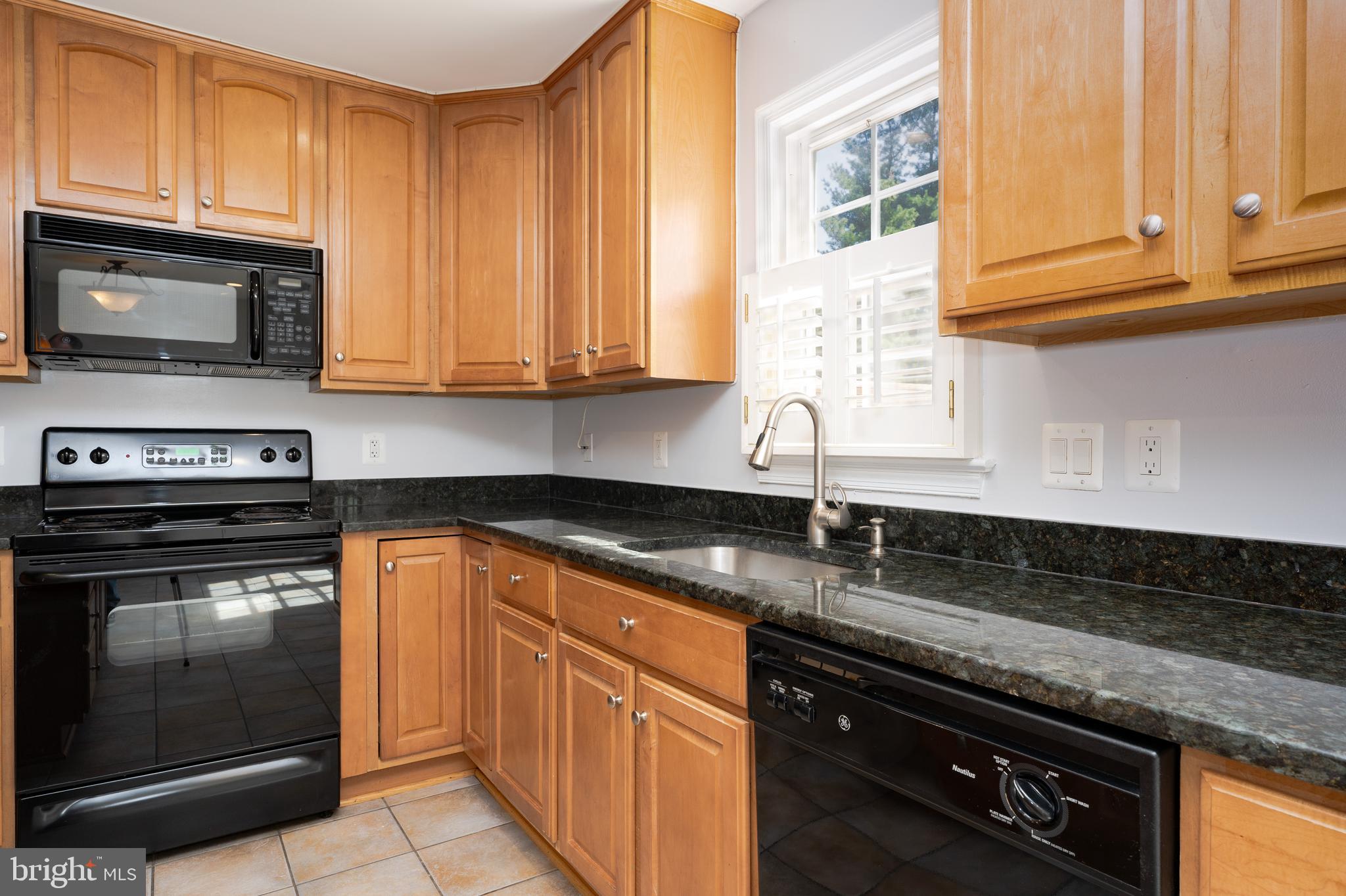 2011 Pieris Court Vienna, VA 22182 - Photo 10 of 39 a kitchen with granite countertop cabinets stainless steel appliances and a sink