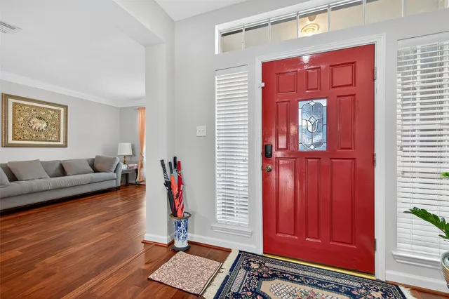 a living room with furniture a red couch and a window