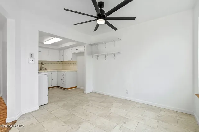 a view of kitchen with a sink and a refrigerator