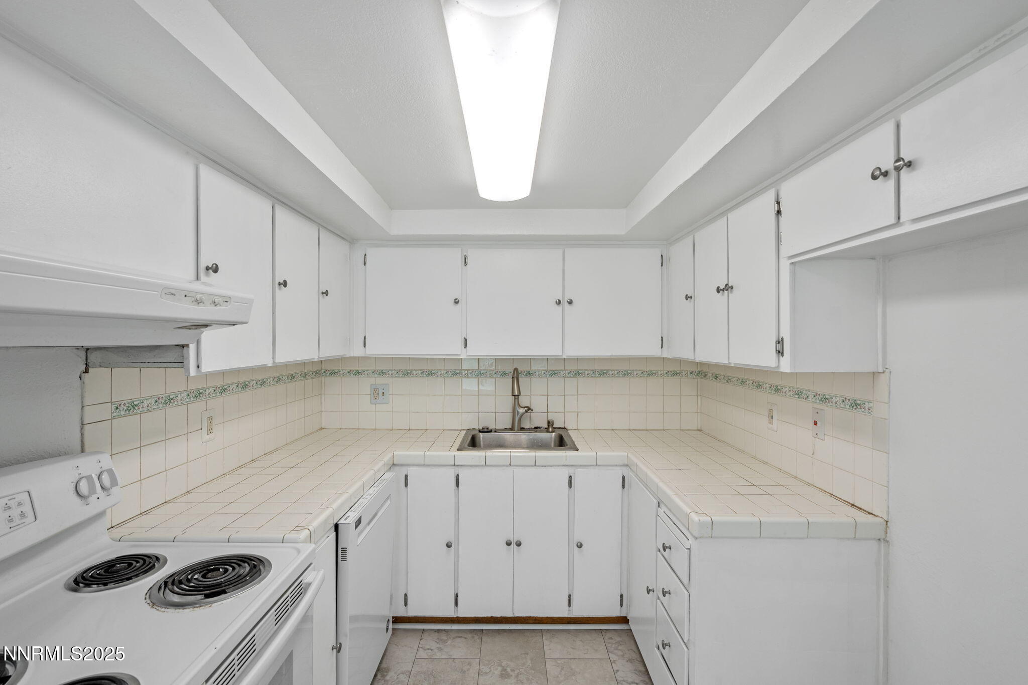 1889 Merchant Street Sparks, NV 89431 - Photo 15 of 28 a kitchen with a sink a stove and cabinets