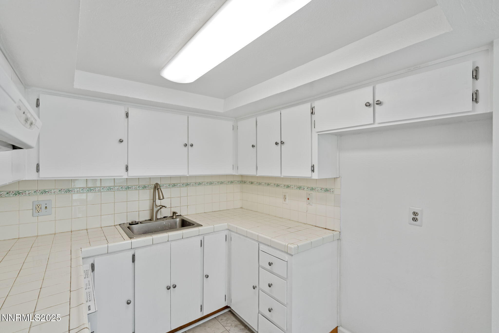 1889 Merchant Street Sparks, NV 89431 - Photo 16 of 28 a kitchen with stainless steel appliances granite countertop white cabinets and a sink