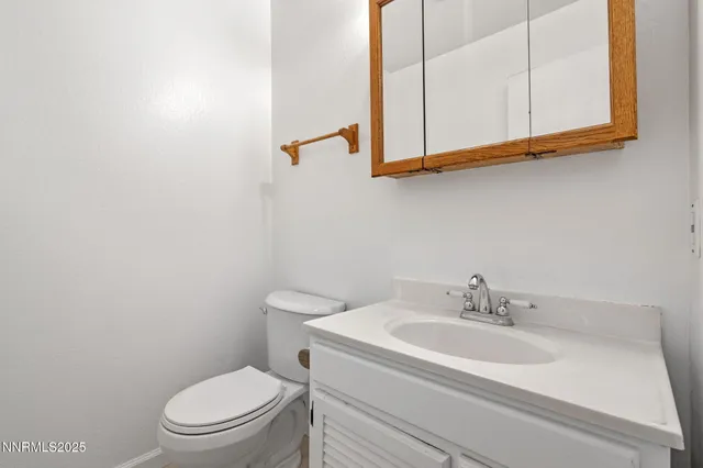 a bathroom with a sink a toilet and mirror