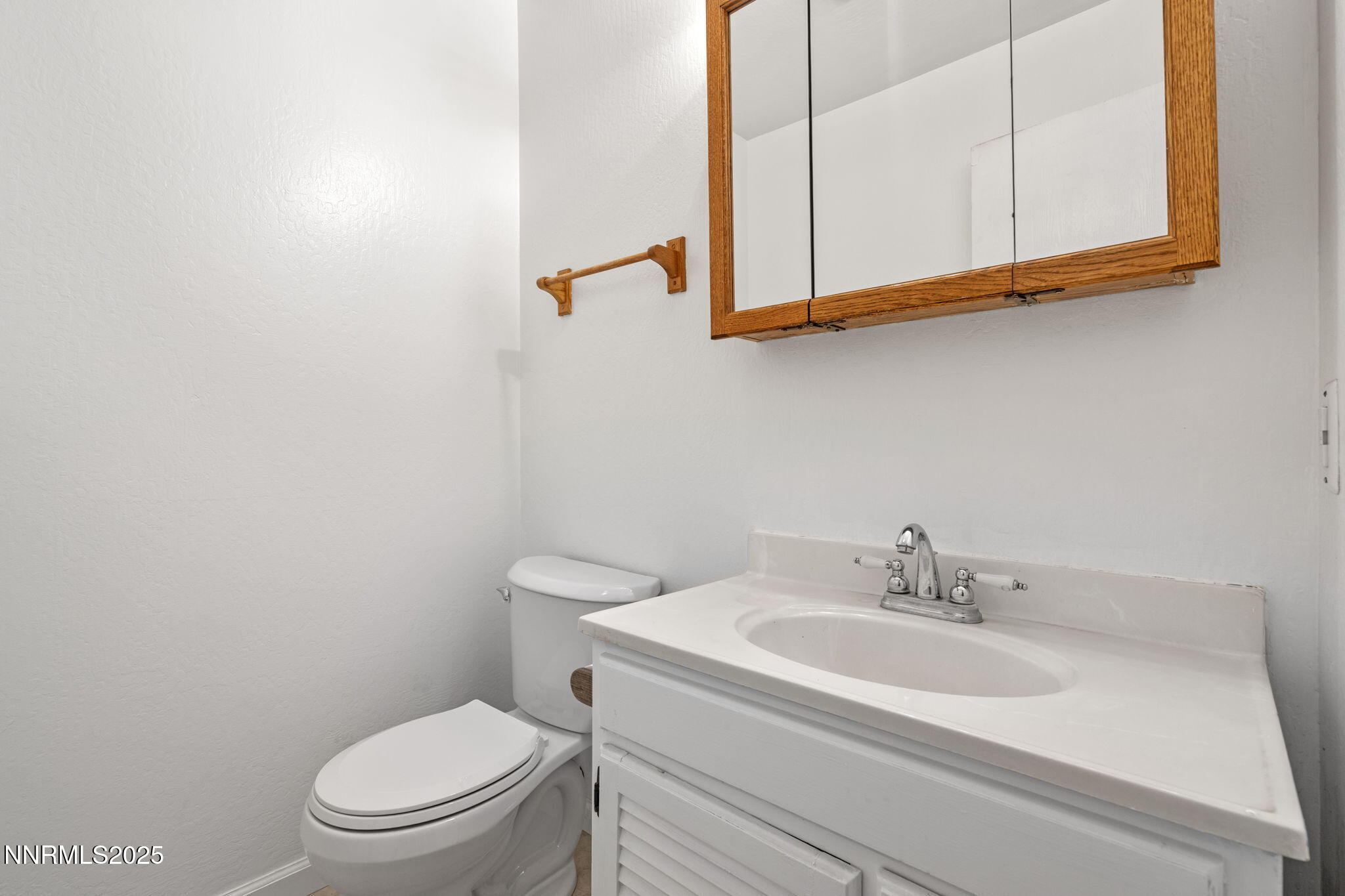 1889 Merchant Street Sparks, NV 89431 - Photo 19 of 28 a bathroom with a sink a toilet and mirror
