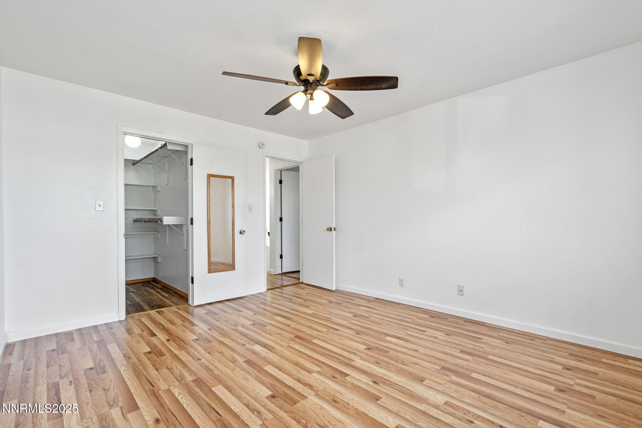 1889 Merchant Street Sparks, NV 89431 - Photo 21 of 28 a view of empty room with wooden floor and ceiling fan