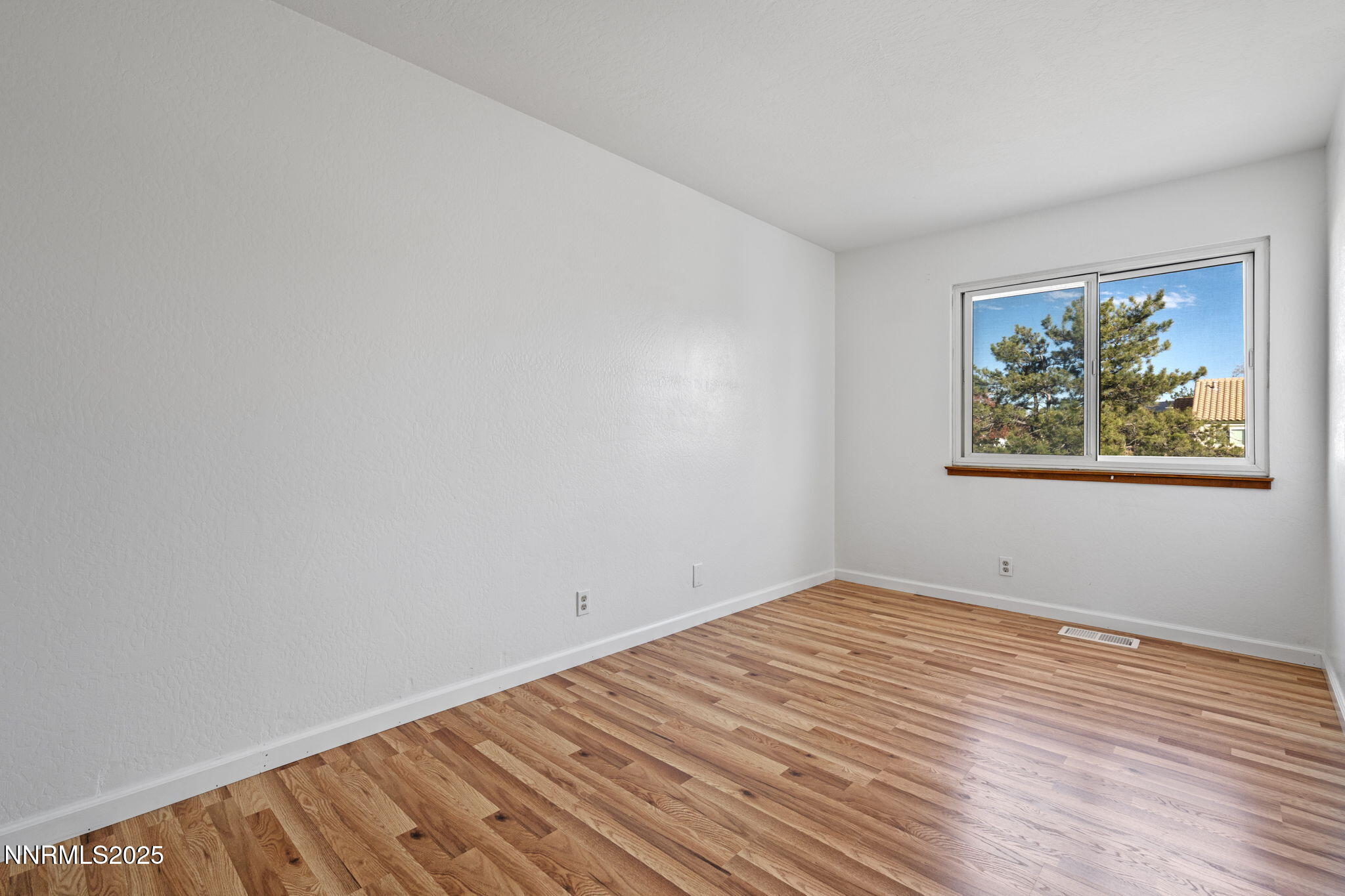 1889 Merchant Street Sparks, NV 89431 - Photo 22 of 28 a view of empty room with wooden floor