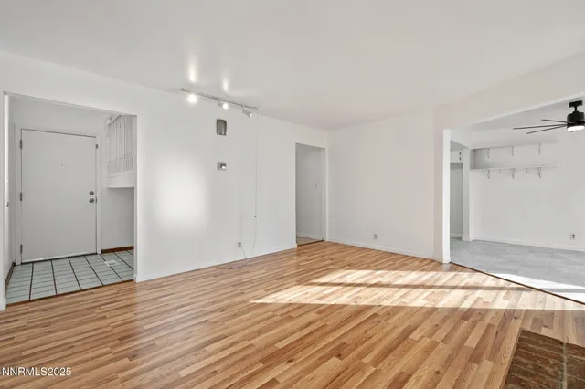 a view of an empty room and wooden floor