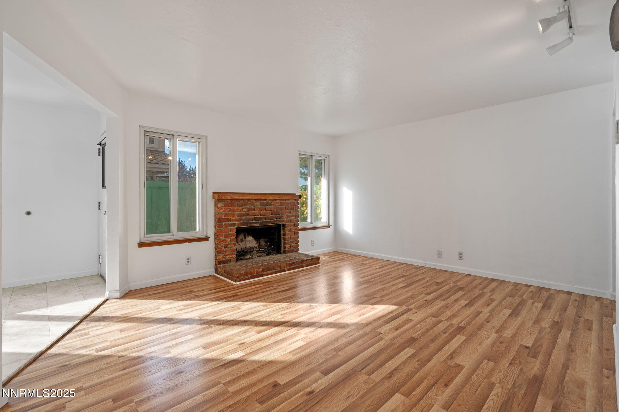 1889 Merchant Street Sparks, NV 89431 - Photo 7 of 28 a view of empty room with wooden floor and fireplace
