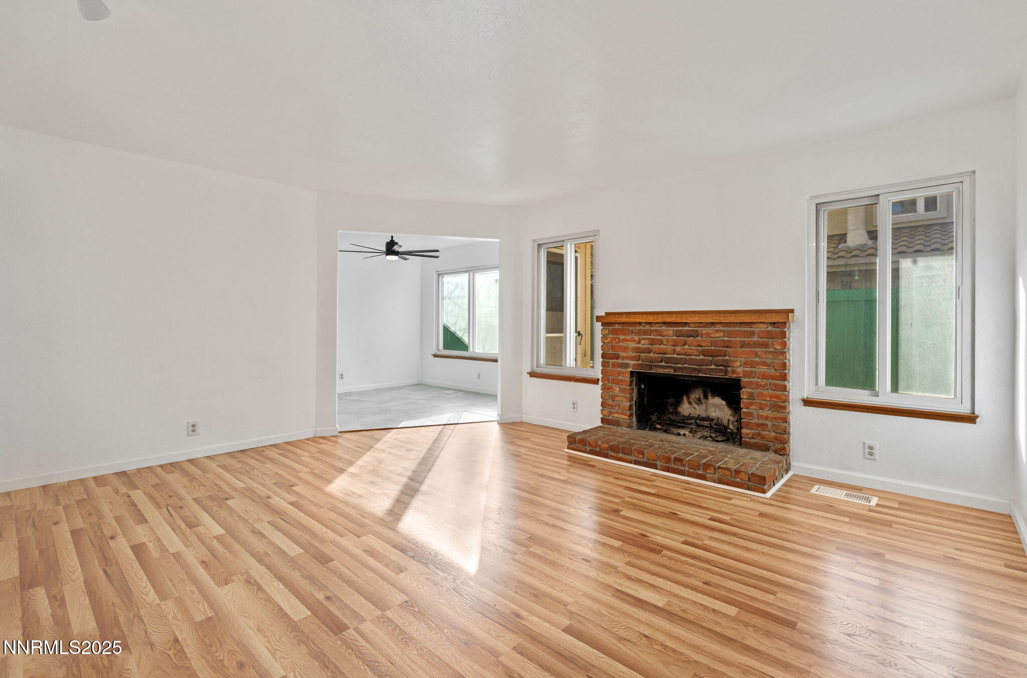 1889 Merchant Street Sparks, NV 89431 - Photo 8 of 28 a view of an empty room with wooden floor fireplace and a window