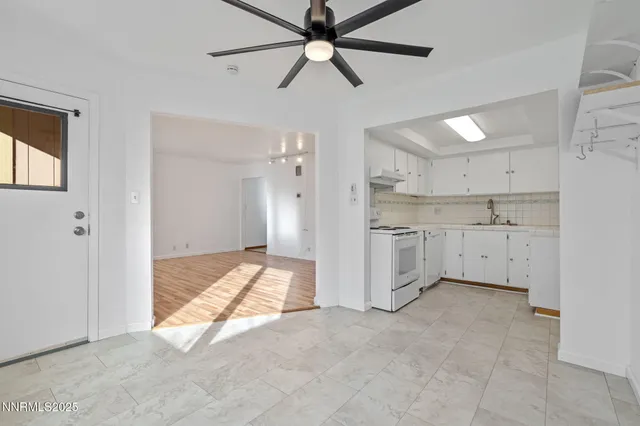 a view of a kitchen with a sink and cabinets