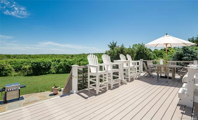 a kitchen with stainless steel appliances granite countertop a refrigerator a stove top oven a sink dishwasher and white cabinets with wooden floor