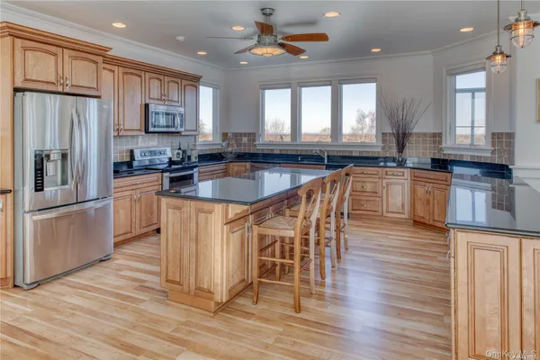 a spacious bedroom with a bed and a large window