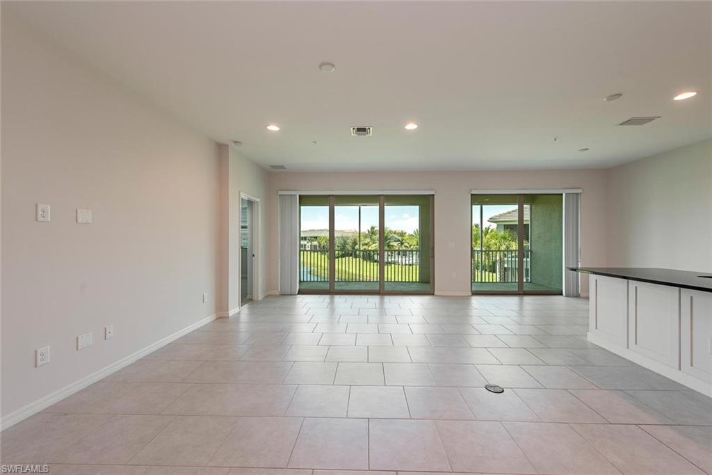 6972 Avalon Circle, Unit 1007 Naples, FL 34112 - Photo 3 of 12 a view of an empty room with windows