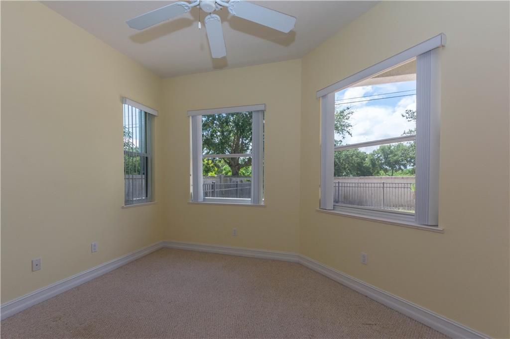 1855 Bridgepointe Circle, Unit 21 Vero Beach, FL 32967 - Photo 14 of 35 an empty room with a window